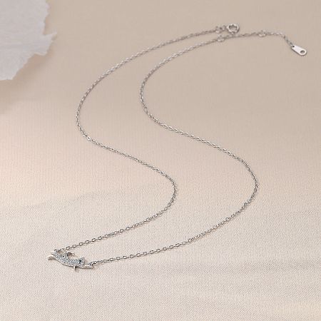 The elegant silver dog pendant necklace displayed on a chain, emphasizing its delicate design.