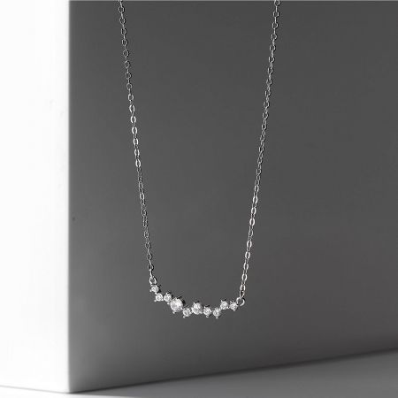 Showcase of the sterling silver smile necklace with a delicate cubic zirconia pendant.