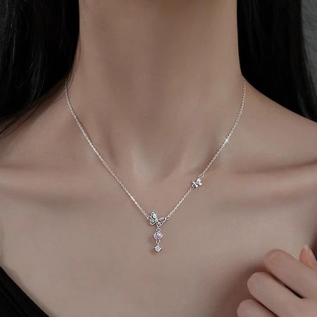 A model wearing the sterling silver butterfly necklace, highlighting its elegant drape.