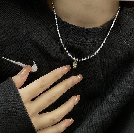 Model wearing the 925 sterling silver gold pendant bead chain necklace, showcasing its length and style.