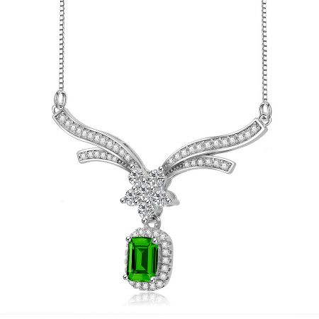 Side view of the emerald necklace, highlighting the unique bird-shaped pendant design.