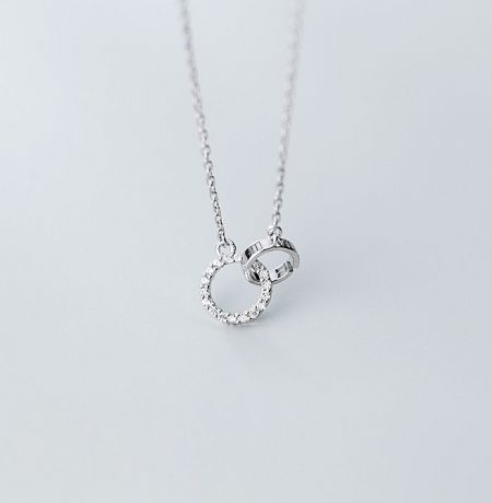 925 Sterling Silver Interlink Circle Necklace - A close-up of the 925 sterling silver interlink circle necklace, showing the detailed craftsmanship of the two interlocking rings, one of which is elegantly paved with sparkling cubic zirconia stones.