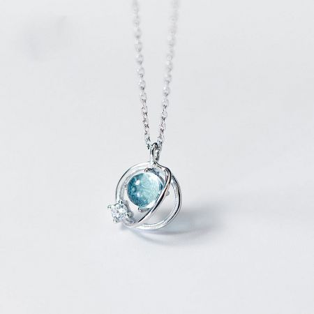 925 Sterling Silver Planet Pendant Necklace Set of 5 - A close-up of a 925 sterling silver planet pendant necklace, featuring a light blue gemstone centerpiece and a smaller clear stone accent, from the set of 5 collection.
