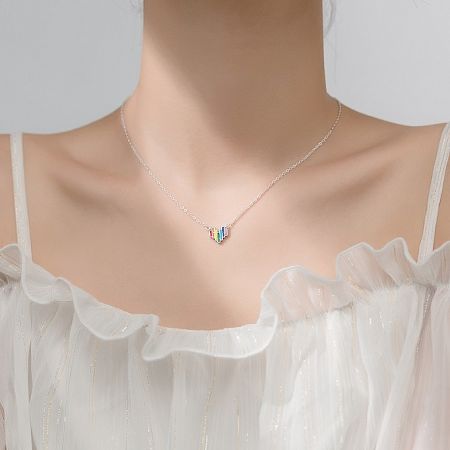 A different angle of the 925 Sterling Silver Rainbow Heart Necklace, showing the pendant's shine and the silver chain.