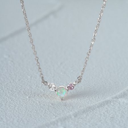 Silver necklace variant with a beautiful pendant holding an opal, a clear diamond, and a pink gemstone.
