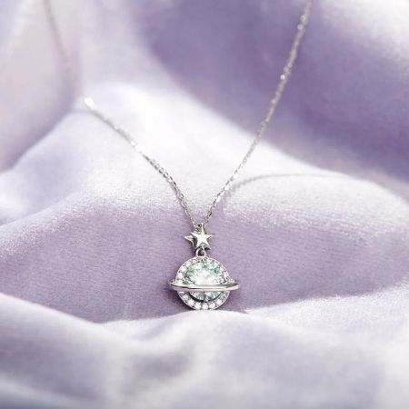 Shining Planet Zircon 925 Sterling Silver Cosmic Necklace Set of 5 - Close-up of the Shining Planet Zircon 925 Sterling Silver Cosmic Necklace, showcasing the detailed planet pendant with a pale blue-green gemstone and a star charm.