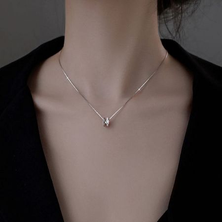 A model wearing the minimalist silver zircon choker necklace, showcasing its elegant fit.