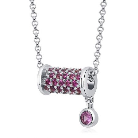 Detailed view of the silver necklace with its cylindrical pendant featuring pink and clear gemstones.