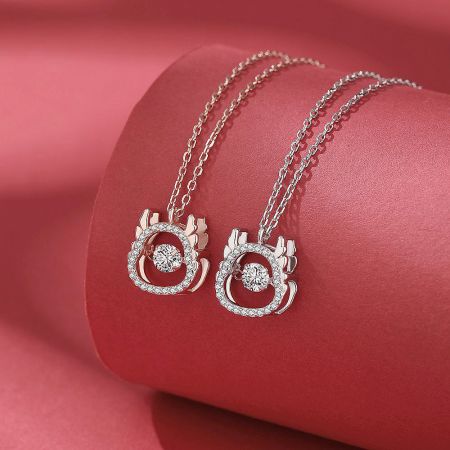 Close-up of the two dragon pendant necklaces, showing the craftsmanship of the sterling silver.