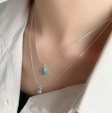Another perspective of the 925 sterling silver necklaces with elegant oval opal pendants.