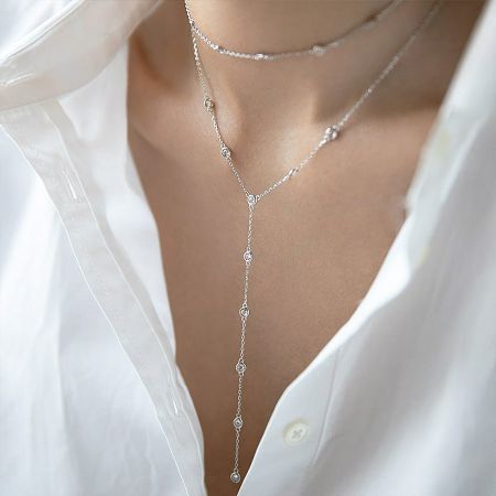 Close-up of the 925 sterling silver Y-necklaces on a model wearing a white shirt, highlighting the minimalist design.