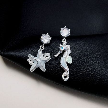 Another perspective of the ocean-themed earrings, showing the delicate pearls and crystal studs.