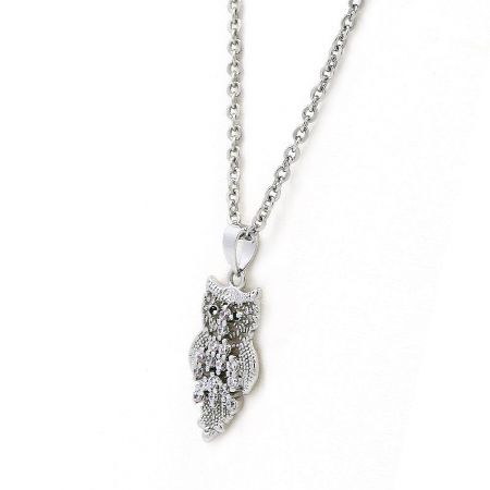 Close-up view of the silver owl pendant necklace, highlighting its textured details and embellishments.