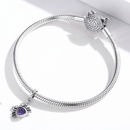 The versatile crab charm shown on a Pandora-style bracelet with other themed charms.