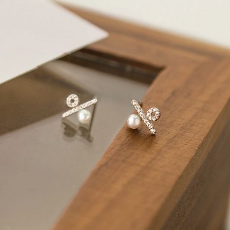 Silver 925 CZ Percentage Symbol Pearl Stud Earrings (5 Pairs) - A pair of Silver 925 stud earrings featuring a delicate pearl and a crisscross design adorned with sparkling CZ stones, on a clean white background.