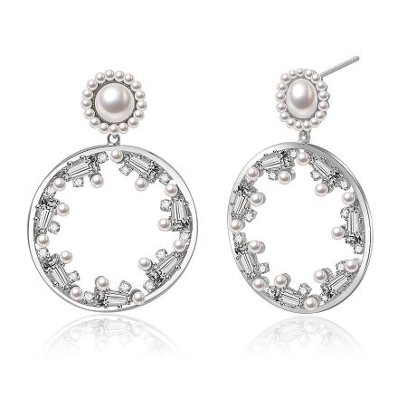 Close-up detail of the Party Round CZ Pearl Earrings, highlighting the baguette-cut crystals and surrounding small pearls.