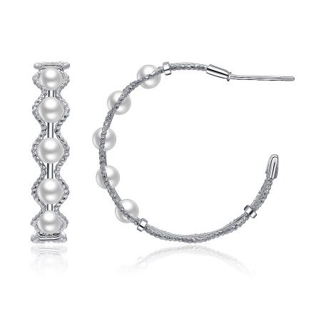 Elegant silver pearl and diamond earrings shown in both hoop and bar designs to display versatility.