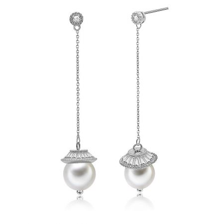 Detailed close-up of the silver pearl and diamond earrings, highlighting the long chain and intricate details.