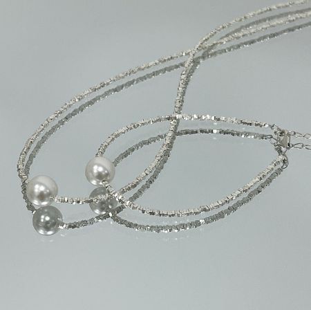 925 Sterling Silver Faceted Beaded Pearl Necklace - Detailed view of the 925 Sterling Silver Faceted Beaded Pearl Necklace, showcasing its multi-strand design with silver beads and prominent freshwater pearls.