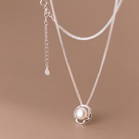 The single pearl necklace shown from a different angle to display its luster and craftsmanship.