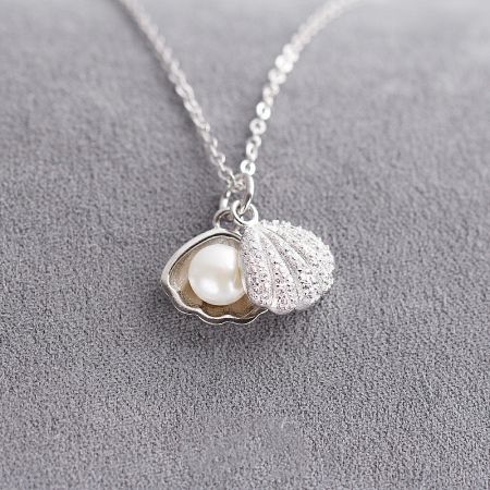 The 925 sterling silver pearl and oyster shell necklace shown from a different angle to highlight its craftsmanship.