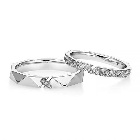 The couple's rings set shown side-by-side, one plain and one with diamond-like stones, illustrating the puzzle-like design.
