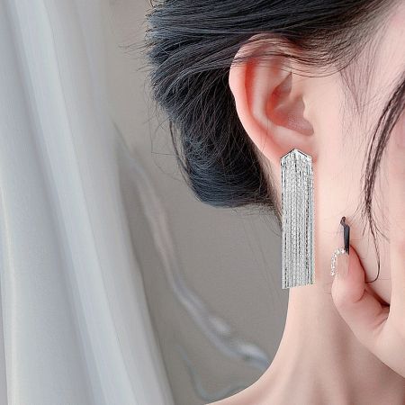 Detailed close-up of the top part of the silver tassel earring, showing the rectangular stud and attachment.