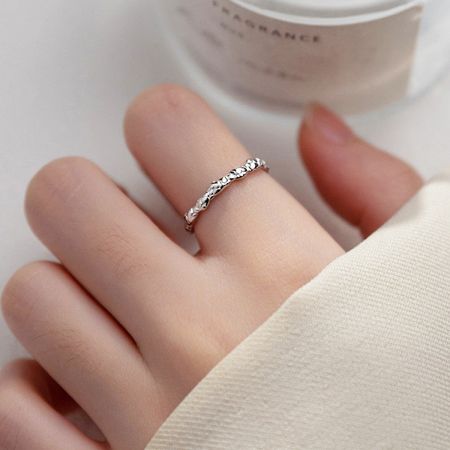 Model wearing the adjustable braided silver ring on the index finger to show scale and fit.
