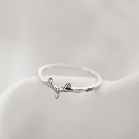 Close-up of a sterling silver ring featuring an artistic whale design.