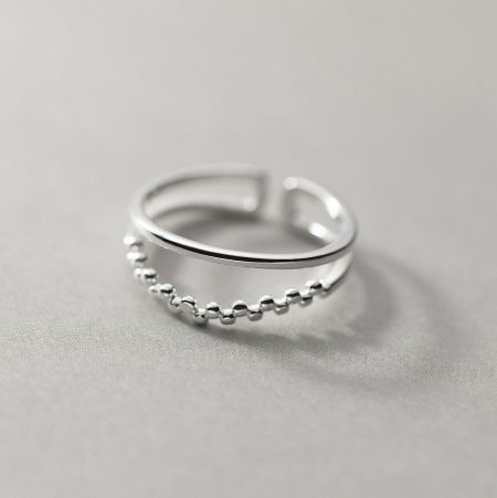 Detailed view of the beaded design on the lower half of the silver ring.