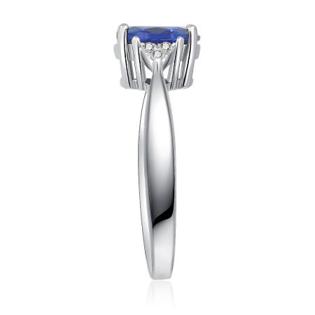 Detailed view of the rhodium-plated brass ring with a brilliant blue created sapphire and double row of zirconia.