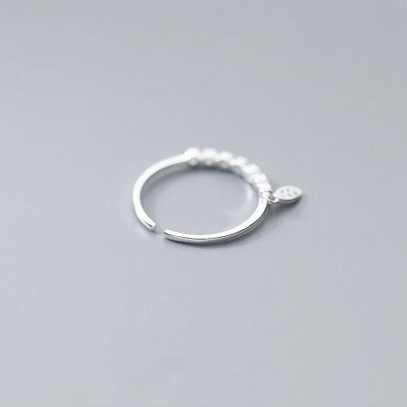 A 925 sterling silver ring with a dangling leaf charm, shown from a different angle.