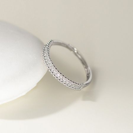 Detailed view of a wholesale 925 sterling silver ring featuring a double beaded edge and sparkling CZ stones.