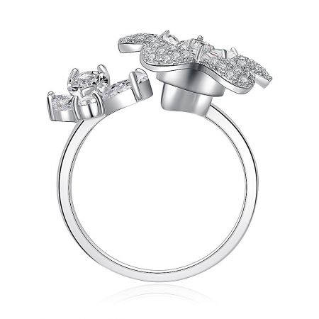 Side profile of the silver Butterfly and Daisy spinning ring on a reflective surface.