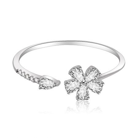 Flower Petal Ring In Rhodium - A close-up of the rhodium-plated 925 sterling silver flower petal ring, showcasing its intricate flower-shaped centerpiece set with sparkling cubic zirconia stones.