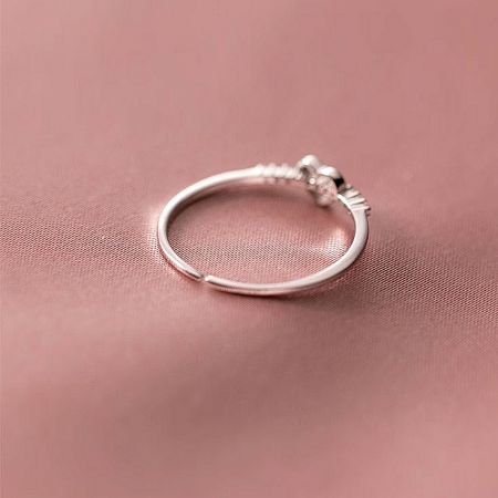 A minimalist silver adjustable ring with a single small gemstone, included in the heart ring set.