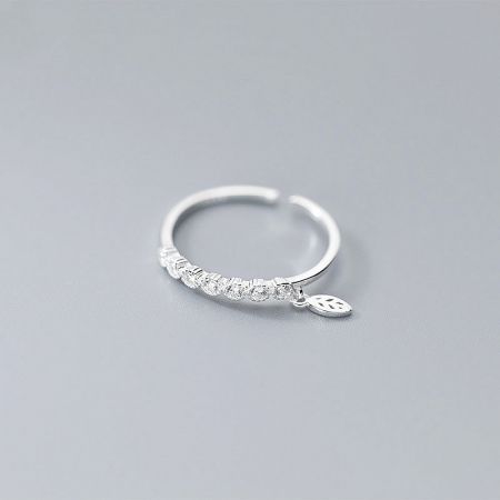 Detailed view of the sterling silver ring highlighting the leaf charm and cubic zirconia stone.