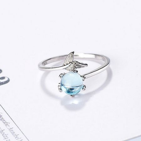 A minimalist 925 sterling silver ring highlighting a beautiful light blue gemstone.