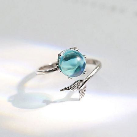 925 Sterling Silver Opening Design Mermaid Tail Index Finger Ring Set of 5 - A close-up of a 925 sterling silver ring from the mermaid tail motif set, featuring an intricate wing-like design and a sparkling light blue gemstone.