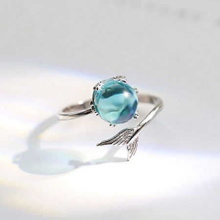 925 Sterling Silver Opening Design Mermaid Tail Index Finger Ring Set of 5 - A close-up of a 925 sterling silver ring from the mermaid tail motif set, featuring an intricate wing-like design and a sparkling light blue gemstone.