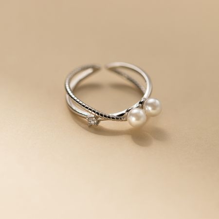 5-Piece 925 Sterling Silver Pearl Crossover Adjustable Ring Set - Close-up of a 925 sterling silver pearl crossover adjustable ring from the 5-piece gift set, featuring a twisted band design with a cubic zirconia stone and two pearls.