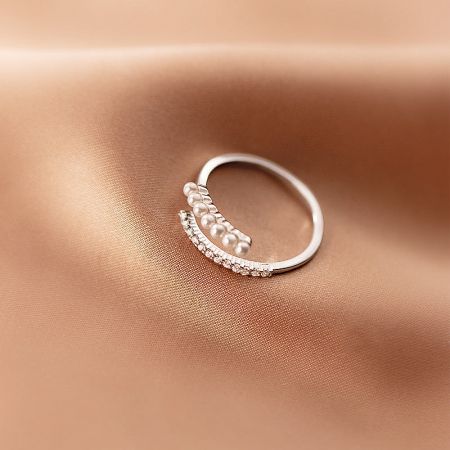 Detailed view of the silver version of the adjustable ring, highlighting the intricate zircon and pearl design.