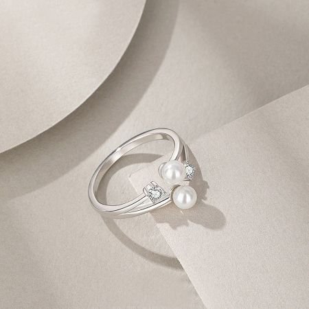 Angled view of the elegant pearl and CZ open ring.