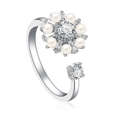 Detailed view of the Silver Spinning Pearl Ring, showcasing the prominent circular design with a large clear gemstone and surrounding pearls.