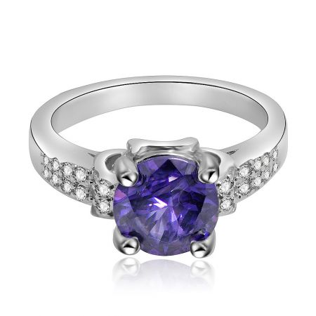 Amethyst and Cubic Zirconia Ring - An elegant Amethyst and Cubic Zirconia Ring featuring a large purple center stone on a silver-colored, rhodium-plated band adorned with smaller white gems.