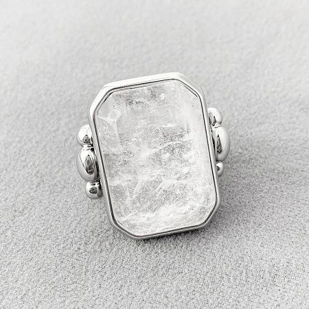 Close-up of a silver-finished ring featuring a prominent rectangular crystal.