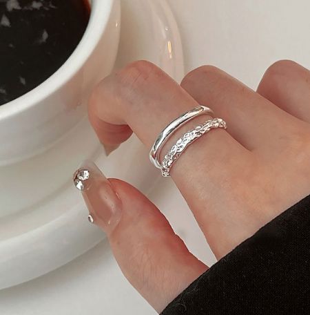 A model wearing the 925 Sterling Silver Double Layer Ring, holding a coffee cup to showcase its elegant style.