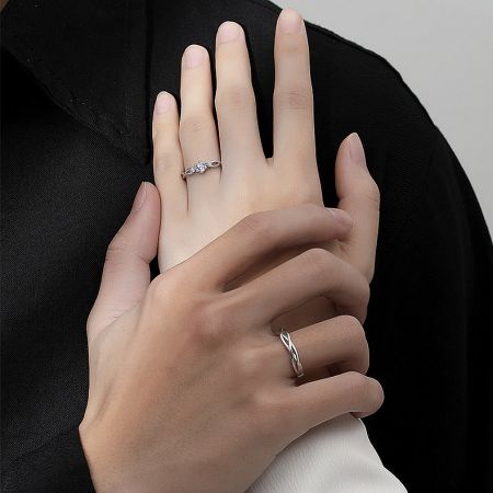 A model wearing the matching his and hers silver rings, demonstrating their stylish and comfortable fit.