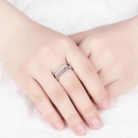 A woman's hand modeling the two-layered sterling silver rings, highlighting their elegant fit and style.