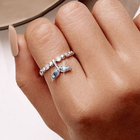 A model's hand showcasing the elegant sterling silver mermaid tail ring set.